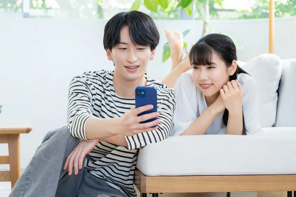 自宅で店を探す若いカップル